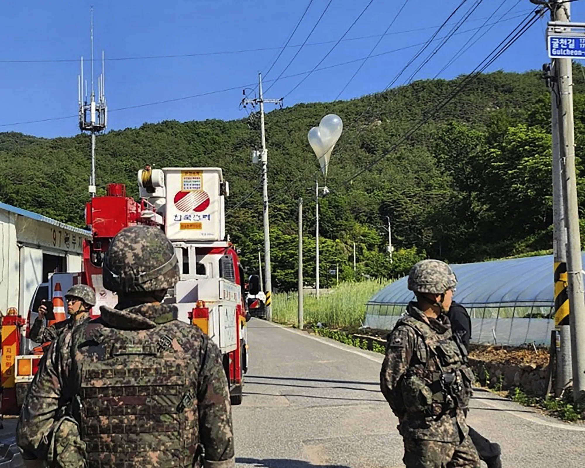 Balloons filled with trash, sent by North Korea, hang on electric wires in Muju, South Korea, on May 29.