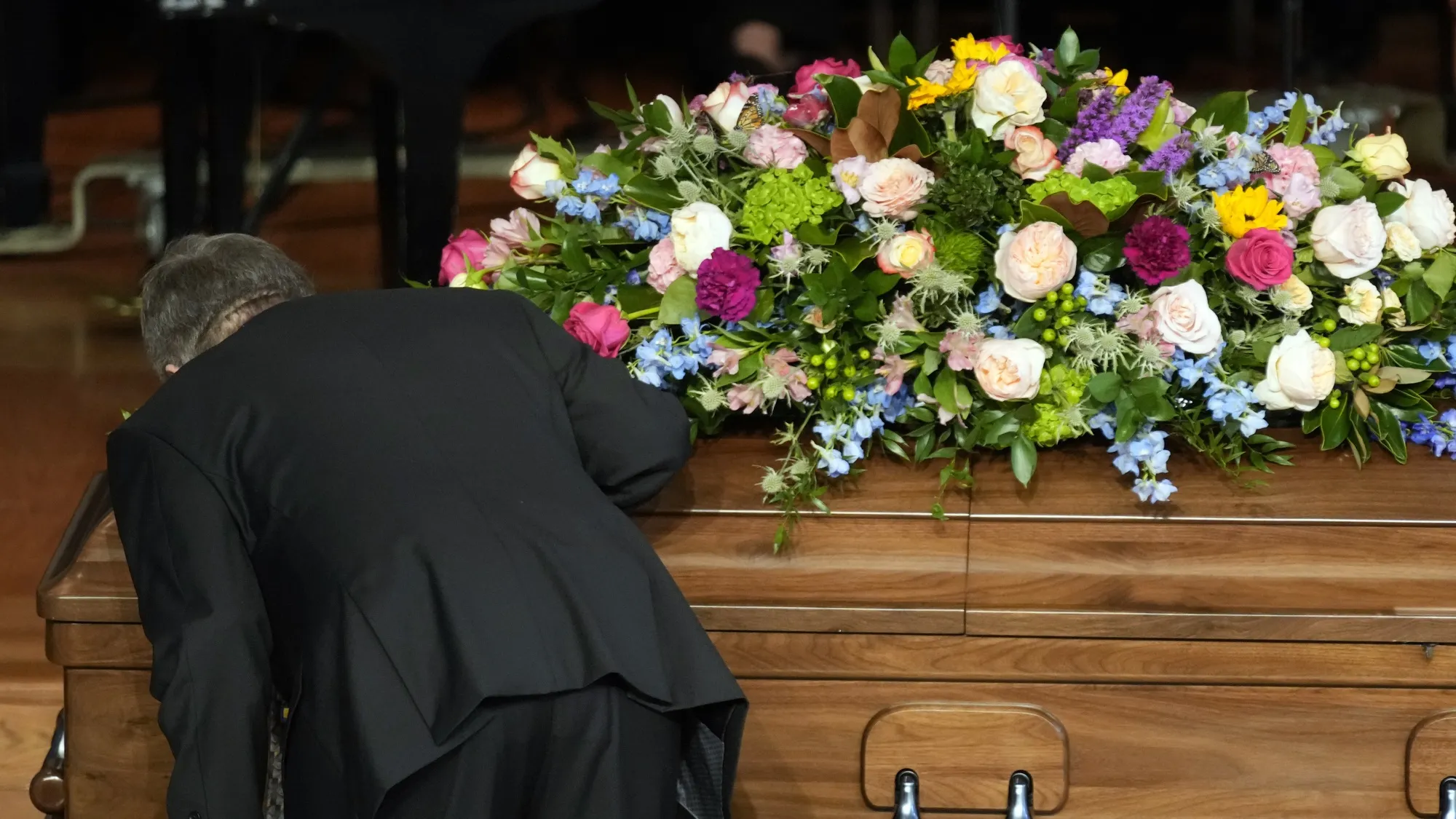 James "Chip" Carter kisses the casket during a tribute service for former first lady Rosalynn Carter, at Glenn Memorial Church, Tuesday, Nov. 28, 2023, in Atlanta. (AP Photo/Andrew Harnik)