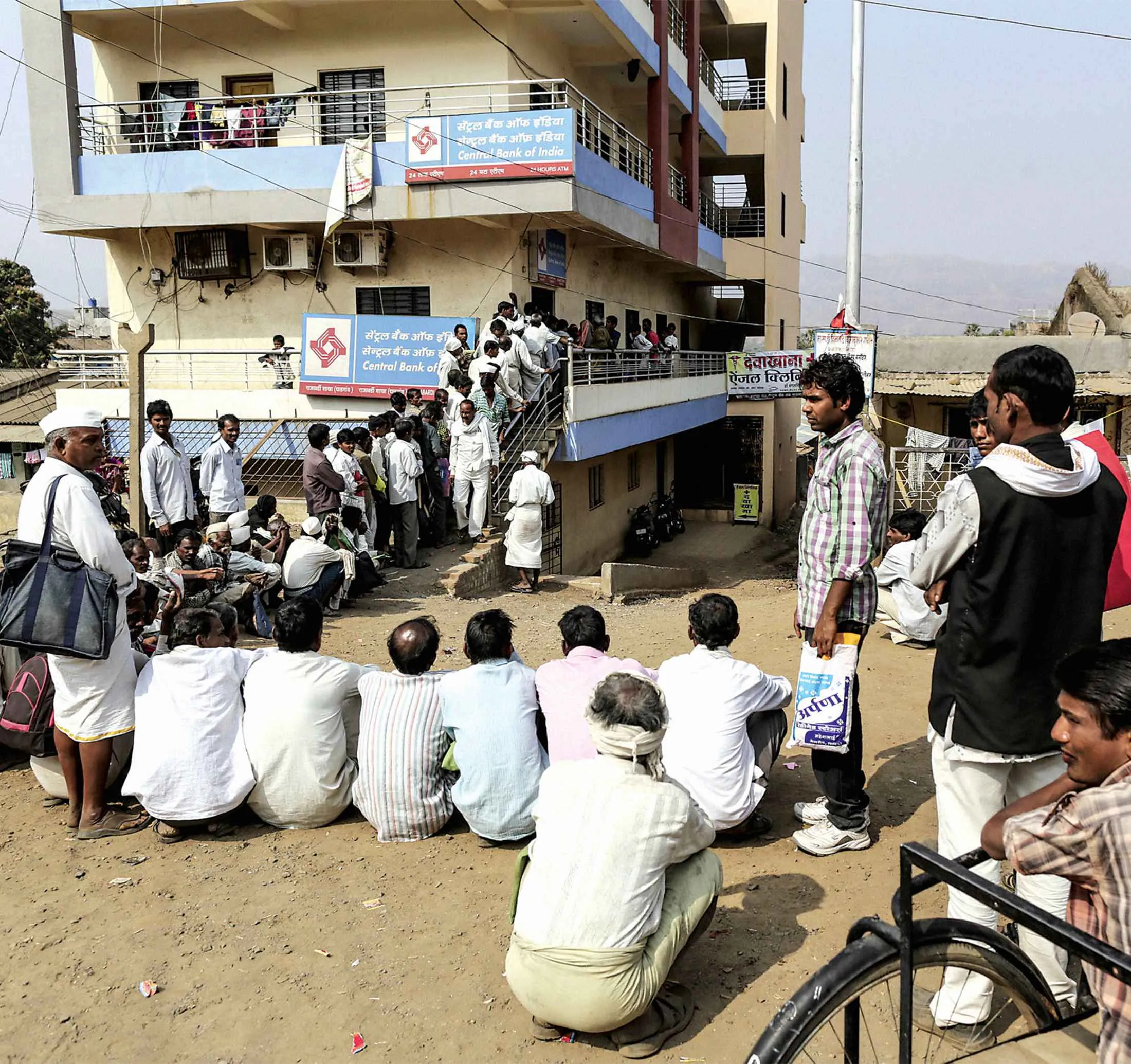 People waiting in line in January to get cash from a bank branch in Dhadgaon, India.
