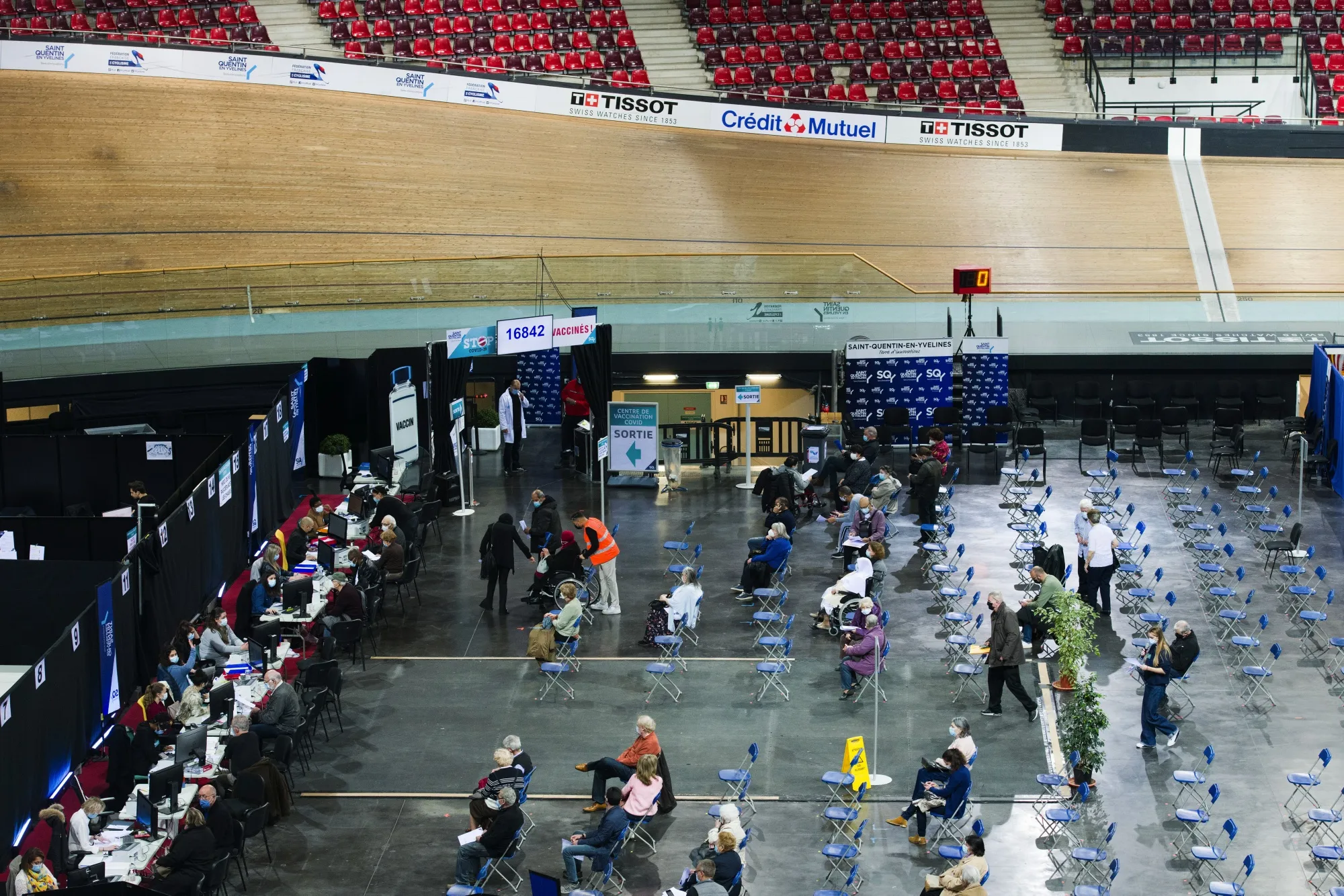 Visitors wait and register for inoculation at the Covid-19 vaccination center inside France's national velodrome in the Saint-Quentin-en-Yvelines district of Paris on March 24.