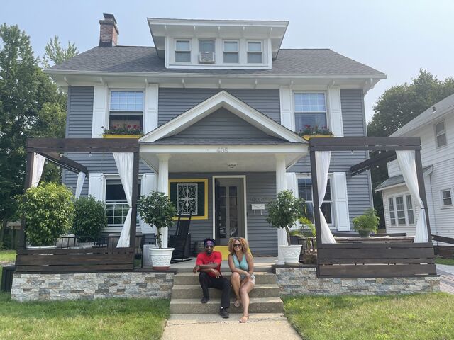 Cousins Ethan West and Dr. Tara L. Conley sitting outside of their grandparents’ former home in Elyria, Ohio. 