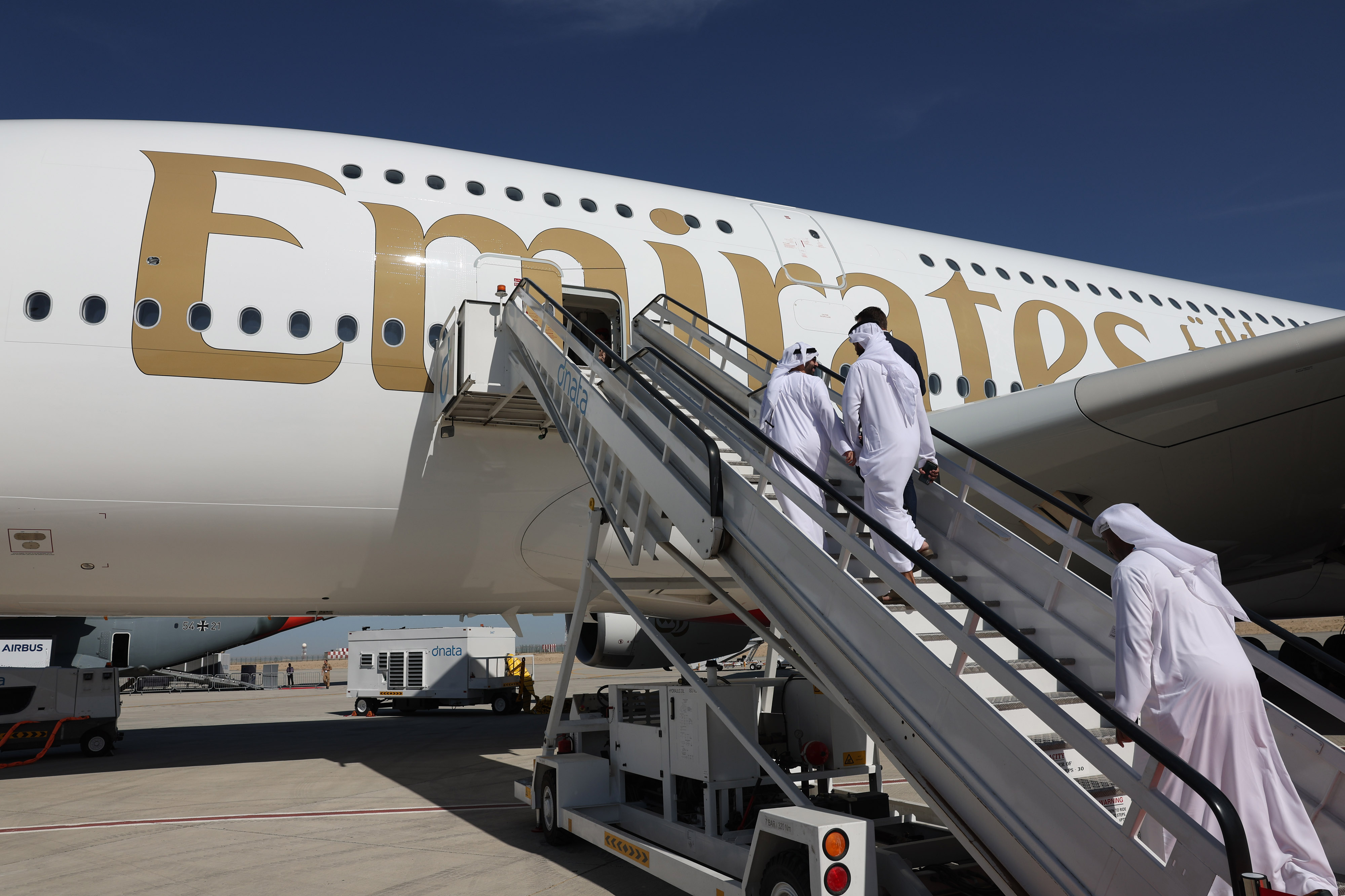 Visitors board an Emirates Airlines passenger aircraft in Dubai, United Arab Emirates.