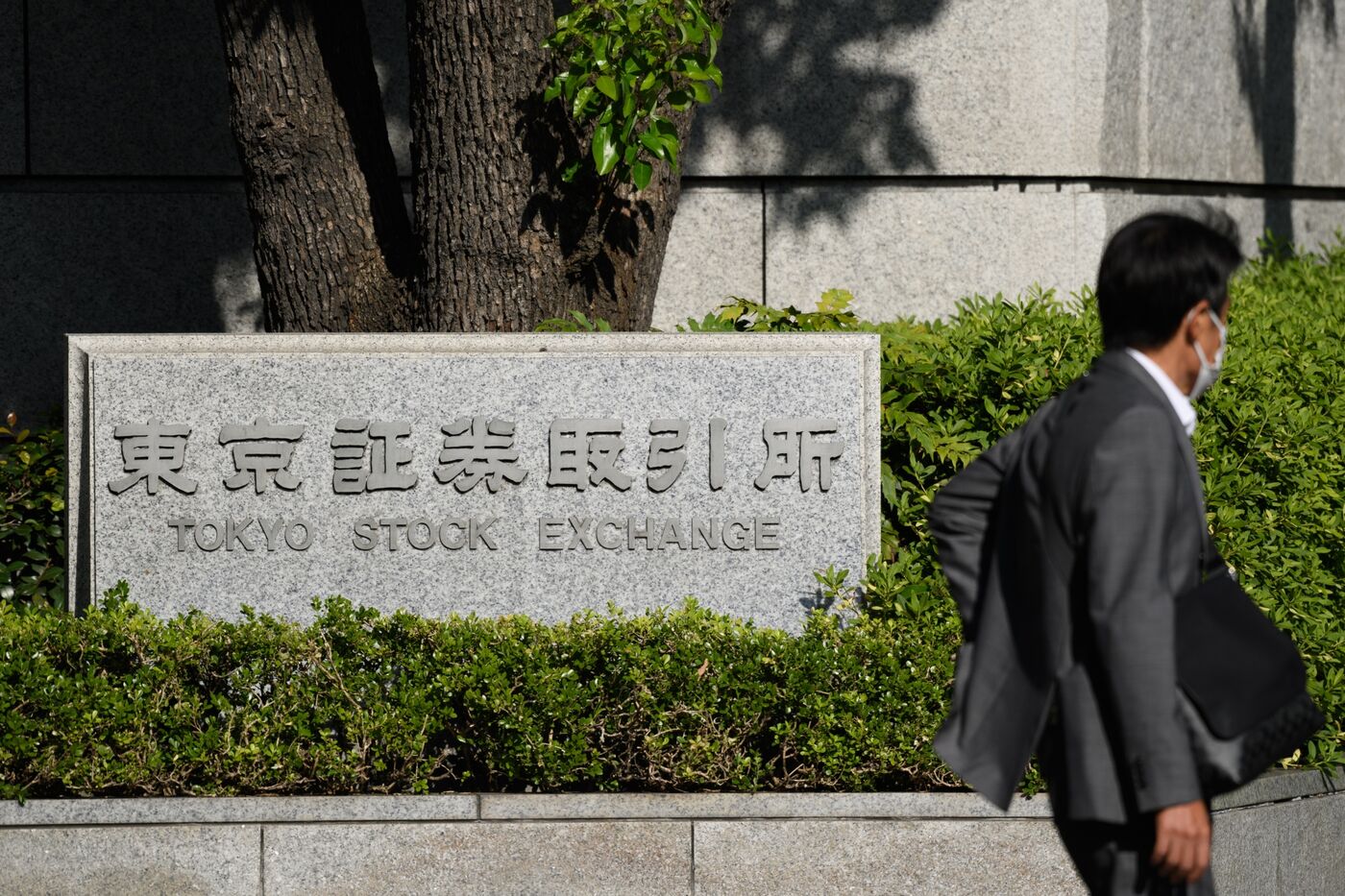 A pedestrians walks past the Tokyo Stock Exchange.