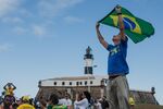 A supporter of Jair Bolsonaro, Brazil's president, waves a Brazilian flag at a rally earlier in July.&nbsp;