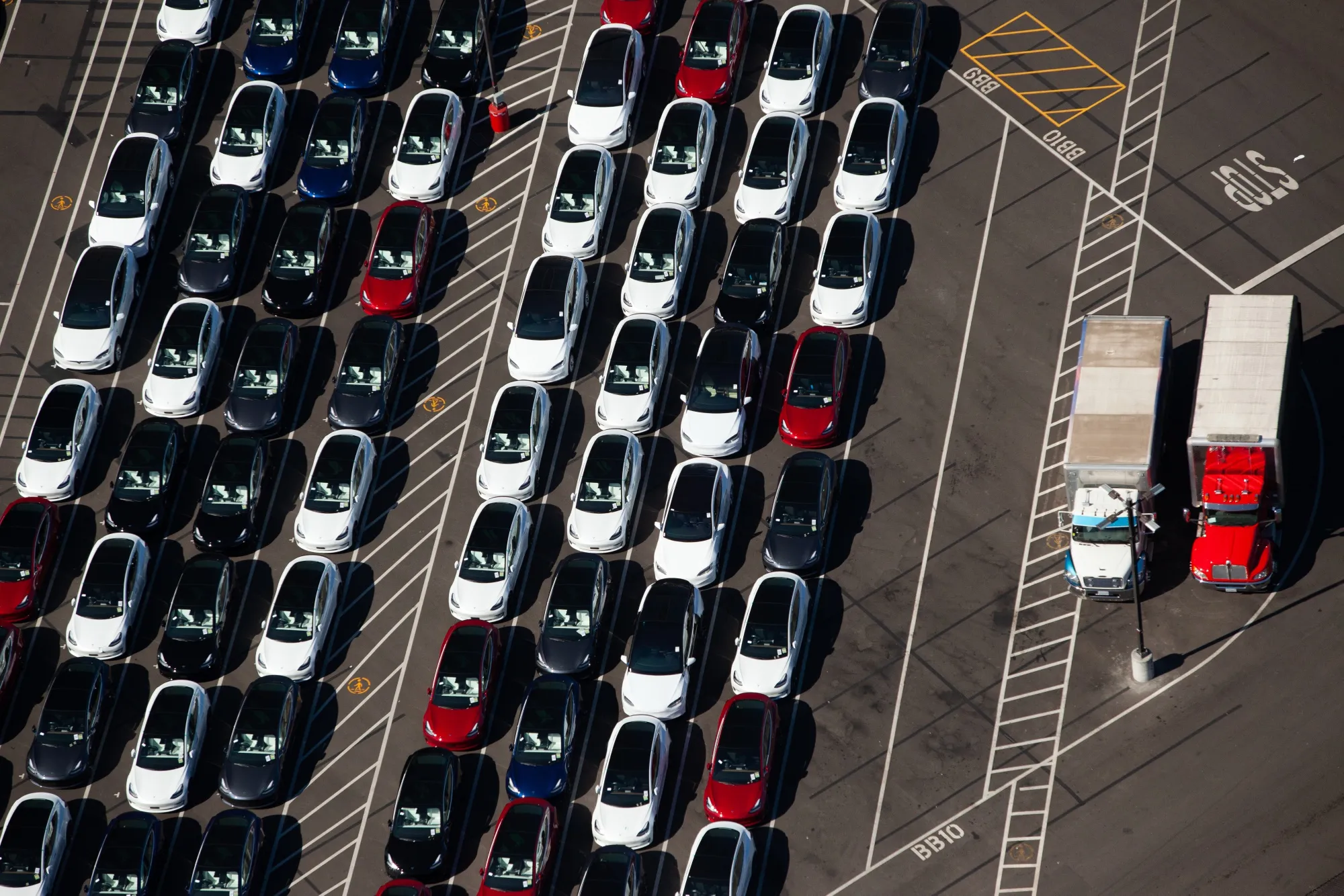 Vehicles sit parked outside of a  Tesla Inc. assembly plant.