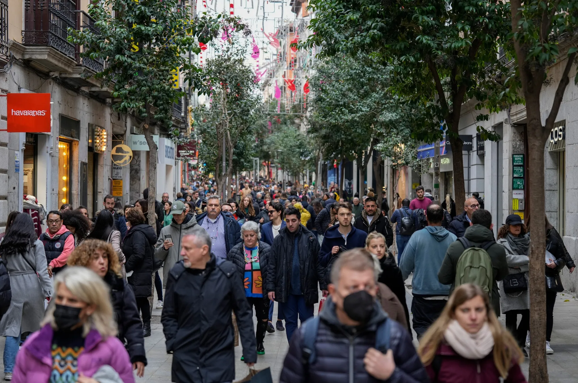 Shoppers make their way along the Calle de Fuencarral retail street in Madrid, Spain, on Dec. 29.