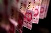 Chinese one-hundred yuan banknotes are arranged for a photograph in Hong Kong, China, on Monday, April 15, 2019. China's holdings of Treasury securities rose for a third month as the Asian nation took on more U.S. government debt amid the trade war between the world’s two biggest economies.