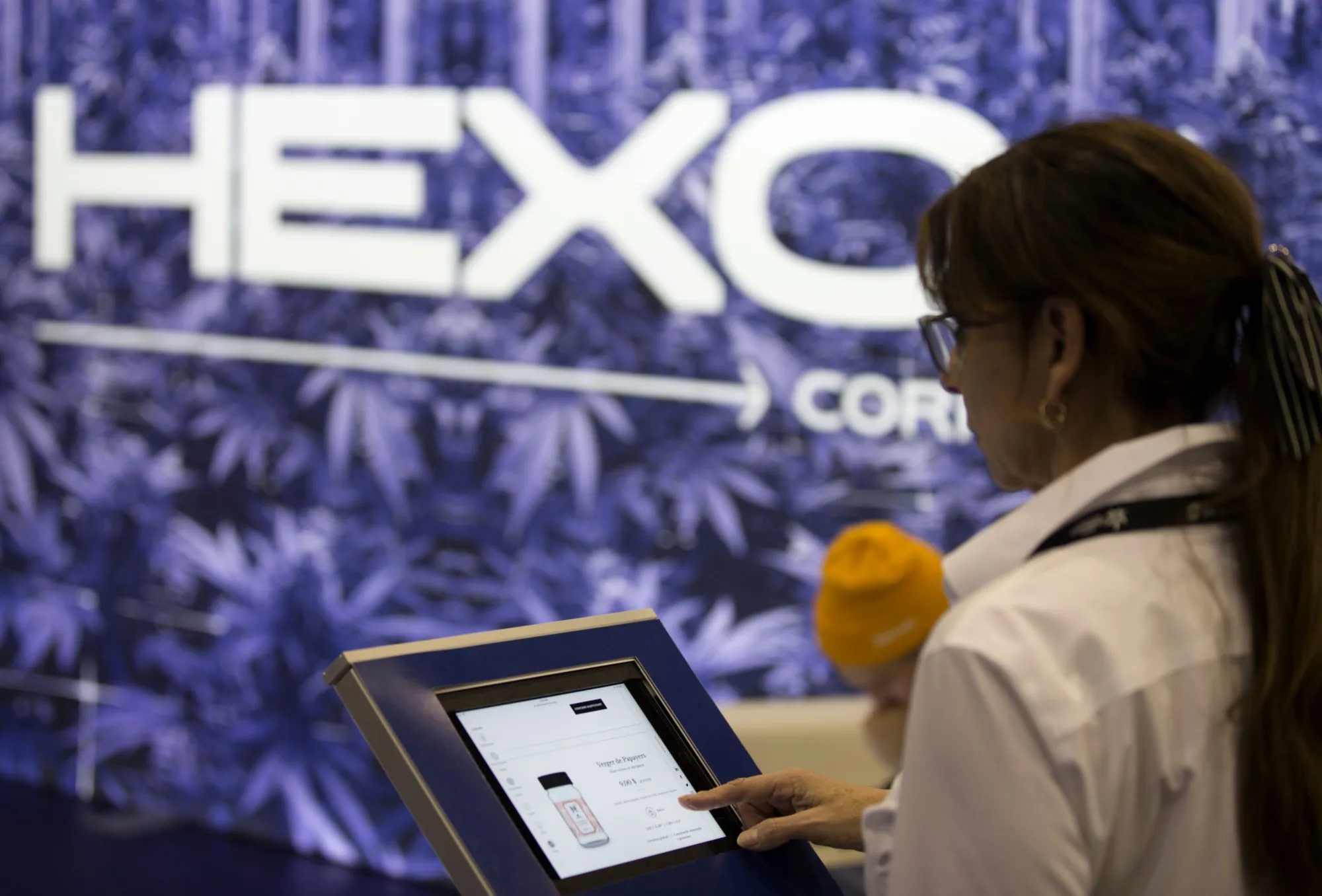A woman browses Hexo products at the Montreal Cannabis Expo on Oct. 26, 2018.