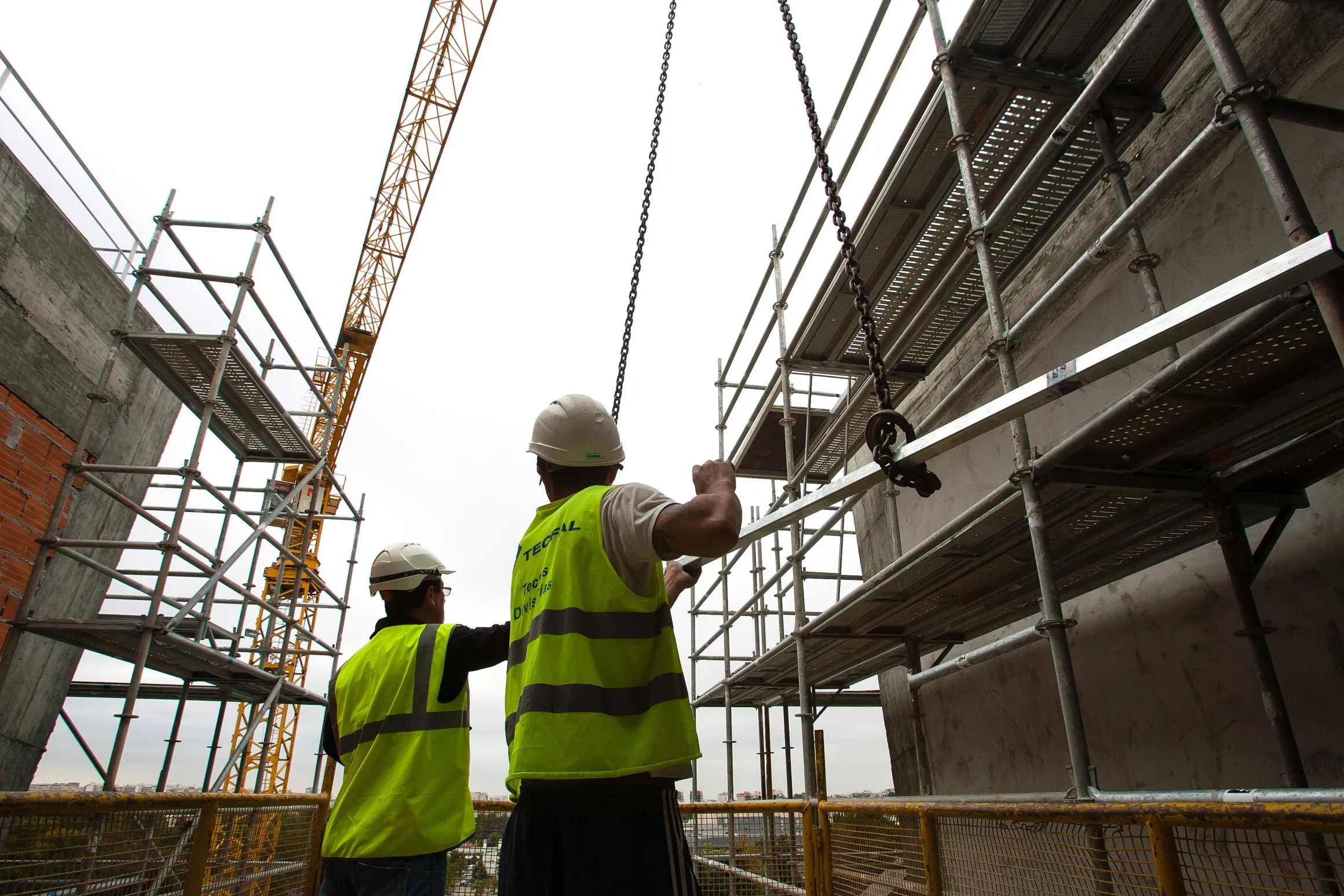 Workers assemble steel frames at a Mota-Engil construction site in Lisbon, Portugal.