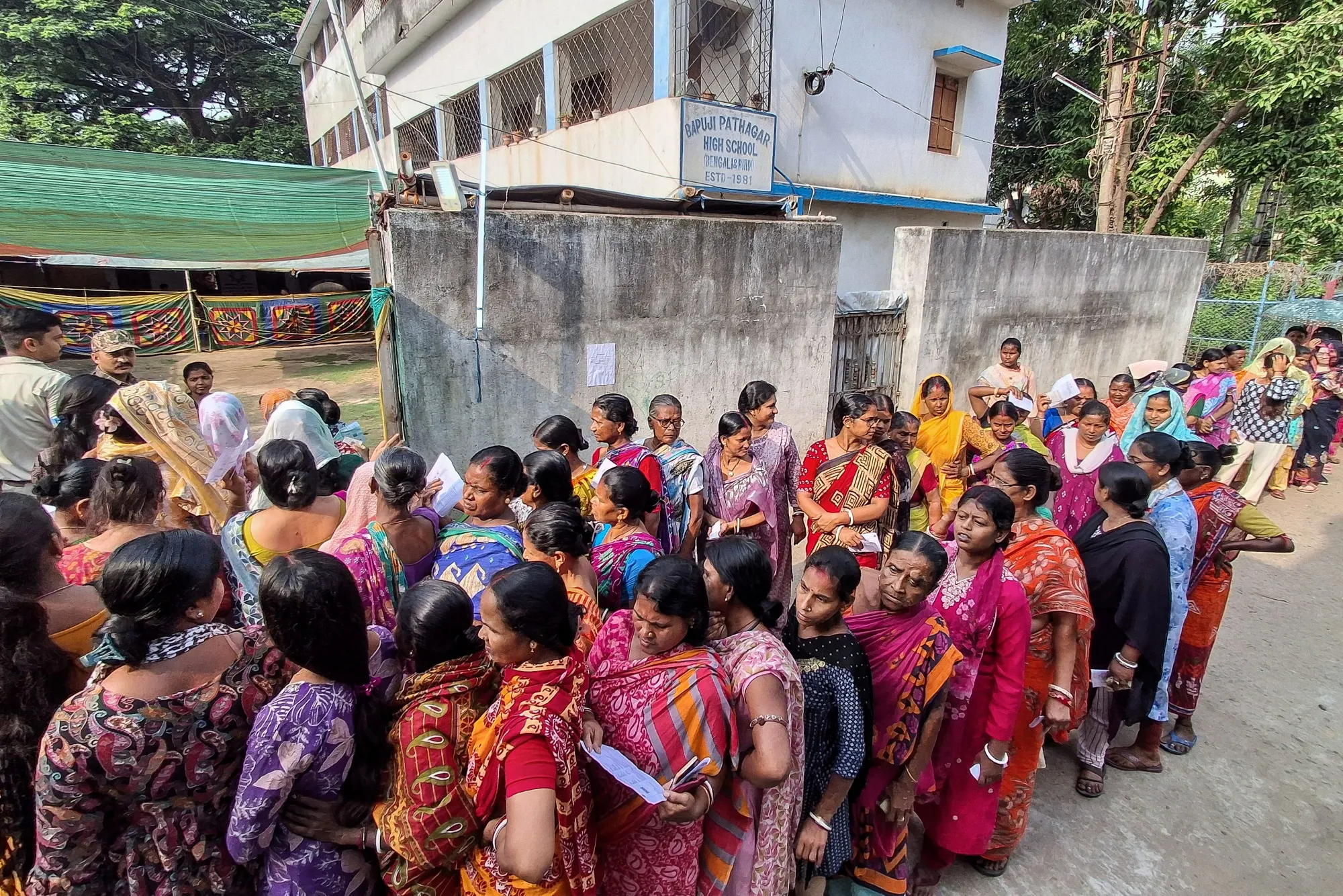 Voters queue up to cast their votes outside a polling station during the West Bengal Legislative Assembly elections&nbsp;on April 23.