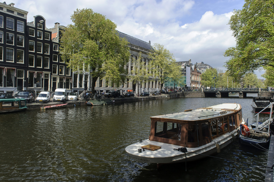 A small boat, used to ferry tourists, is seen moored on a canal in the Dutch city of Amsterdam, Netherlands, on Tuesday, May 14, 2013. Euro-area data this week will probably reveal economic scars of the sovereign debt crisis confirming that the region is now suffering the longest recession since the single currency's creation.