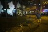 A pedestrian walks past broken glass windows at the Cheung Sha Wan Government Offices during a protest in the Sham Shui Po district of Hong Kong, China on Tuesday, Oct 1, 2019. Police shot tear gas volleys at protesters as simultaneous rallies raged across Hong Kong, including a march through the city center, hours after celebrations for a holiday marking 70 years of Communist rule in China began in Beijing.