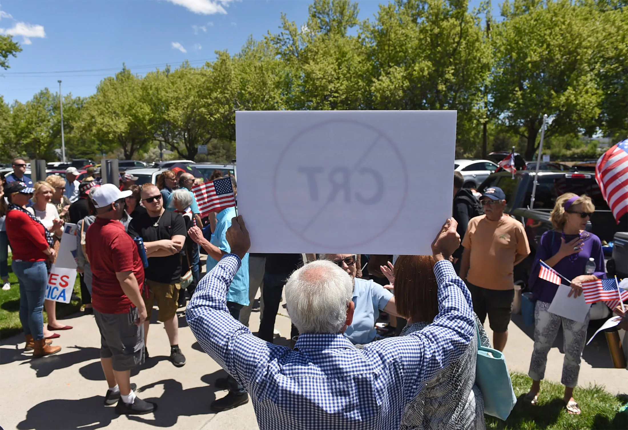 A&nbsp;man holds up a sign against Critical Race Theory during a protest outside a Washoe County School District board meeting in Reno, Nev., on May 25.
