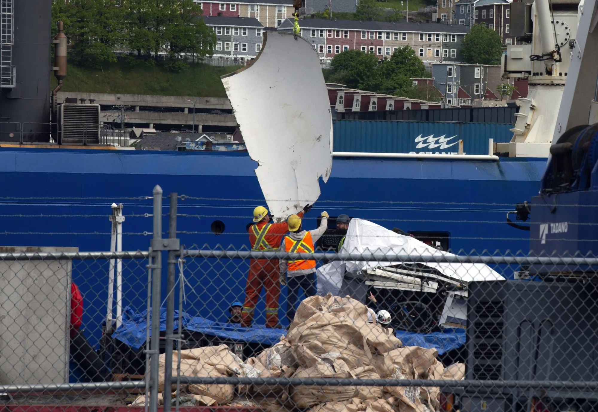 Debris from the Titan submersible, recovered from the ocean floor is unloaded from a ship in St. John's, Newfoundland on June 28.