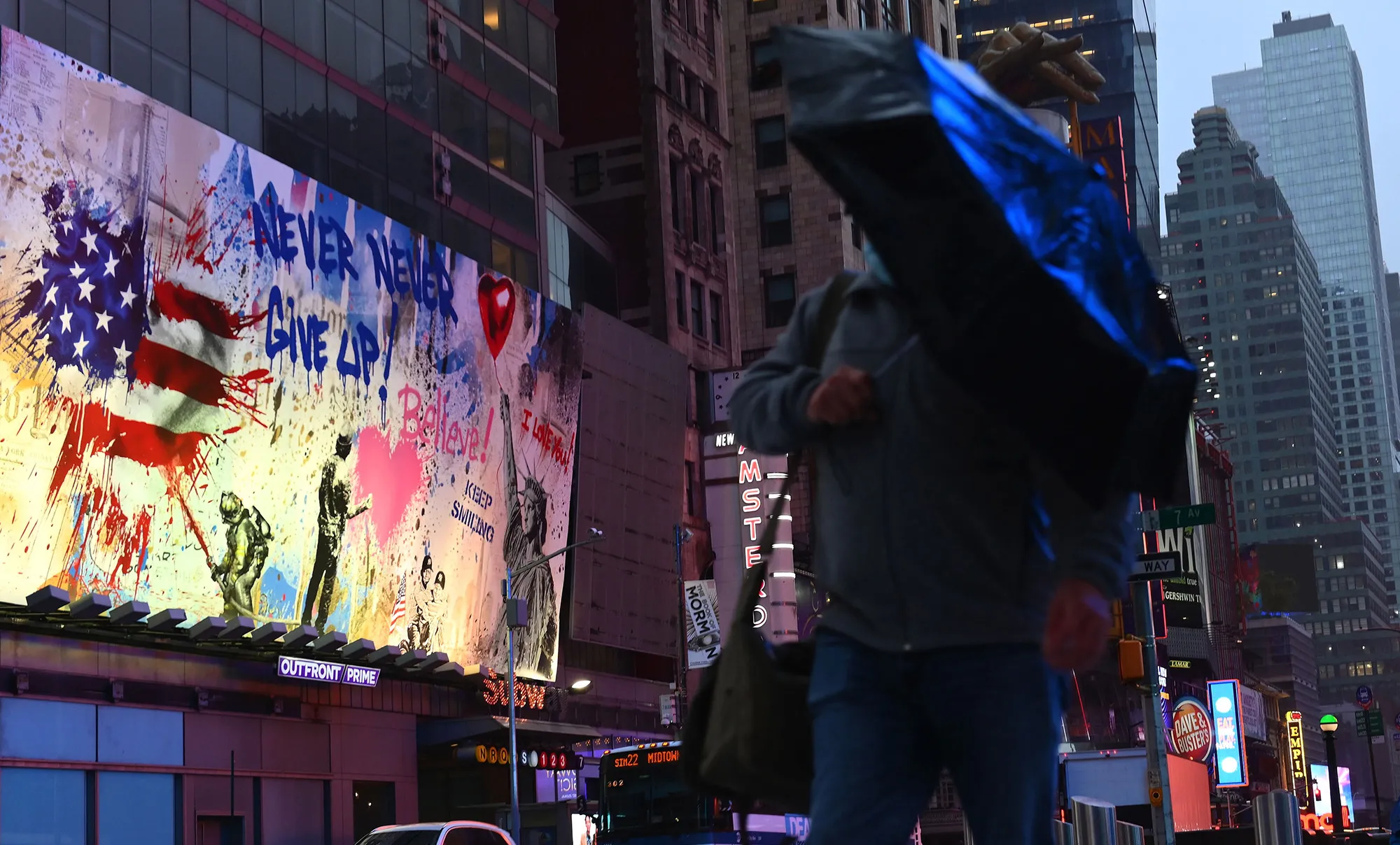 A man walks through Times Square.