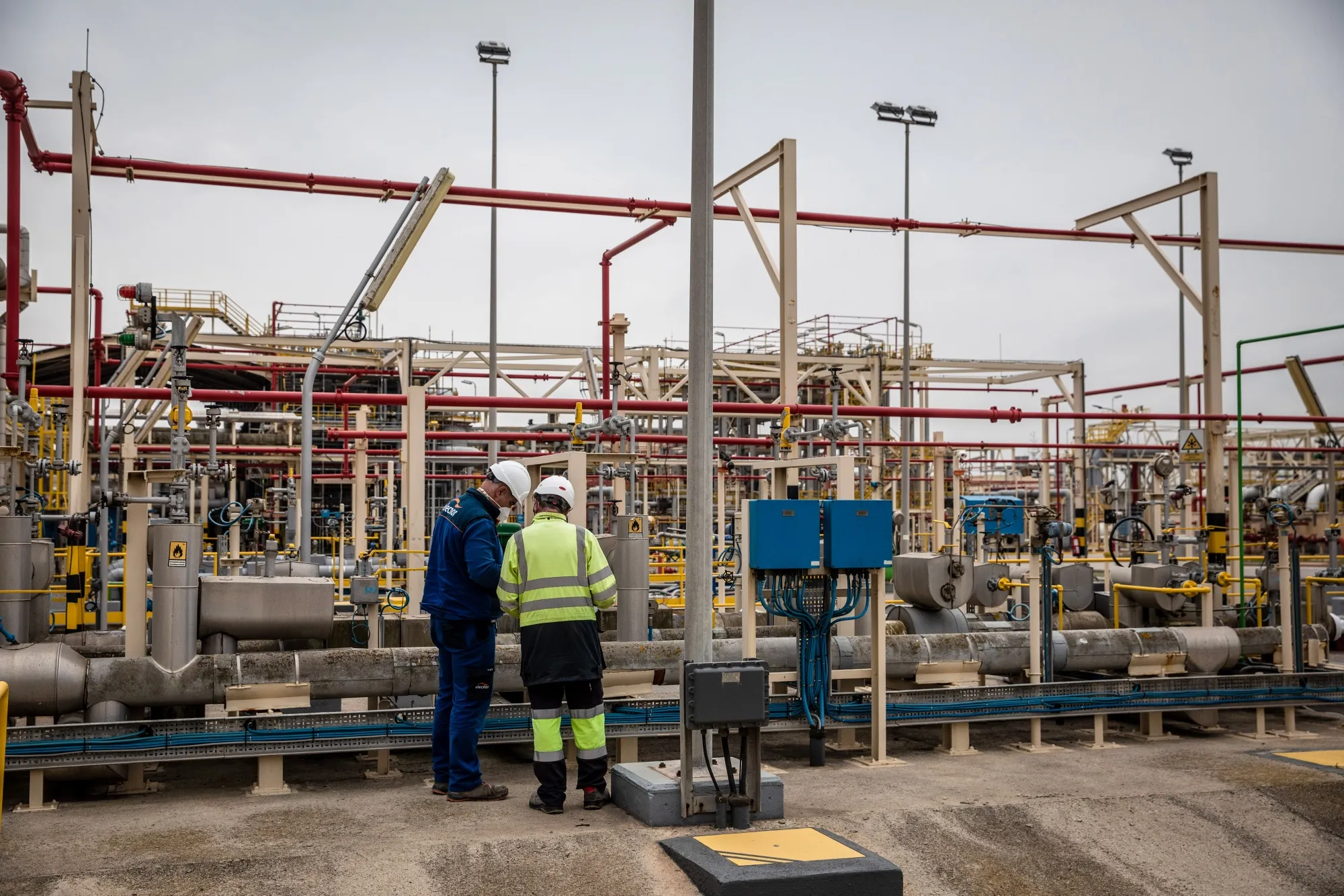 Workers inspect pipework at the Enagas SA storage and distribution hub at the Port of Barcelona in Barcelona, Spain.