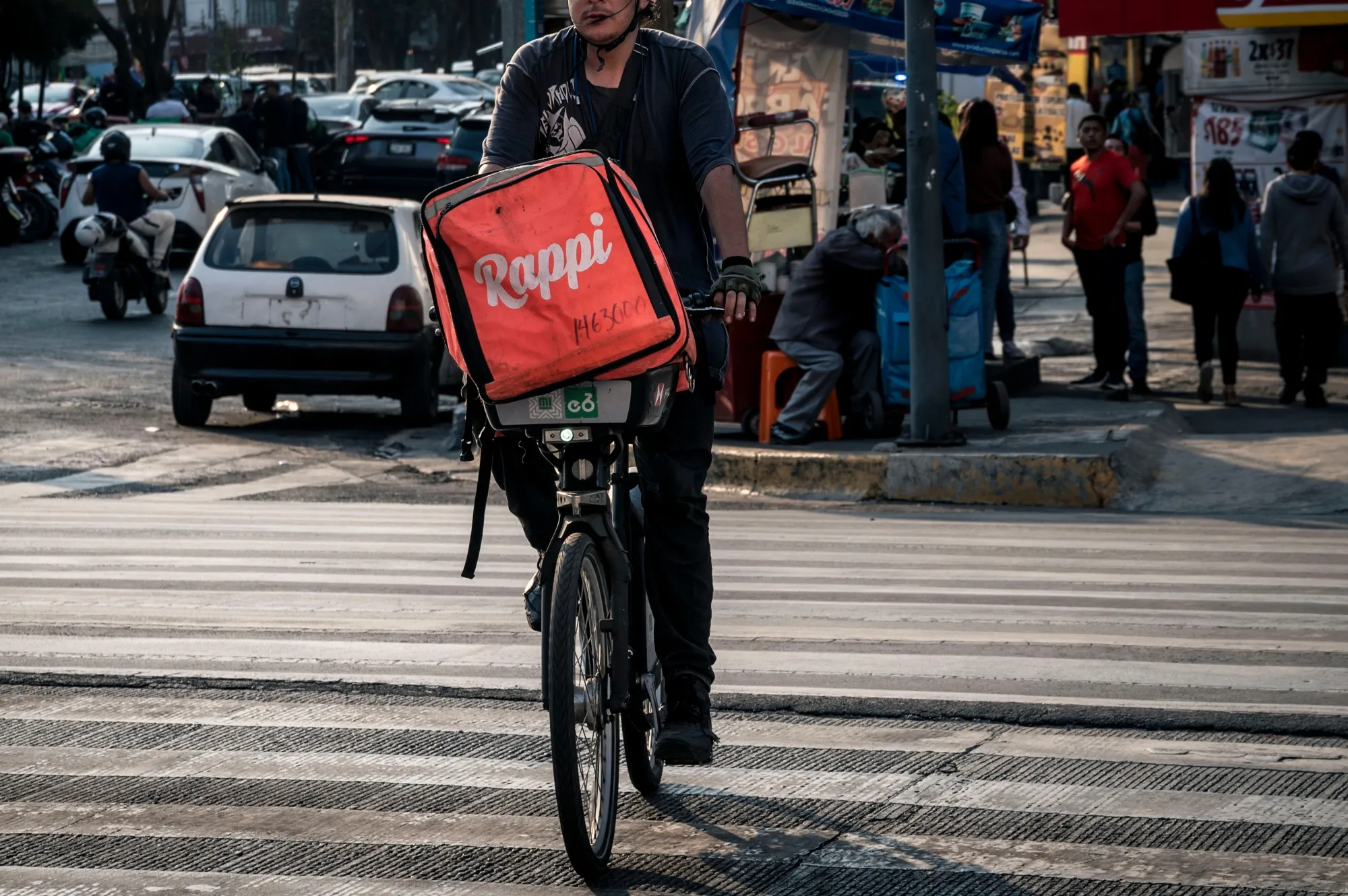 A delivery worker carries a Rappi bag in Mexico City in 2024.