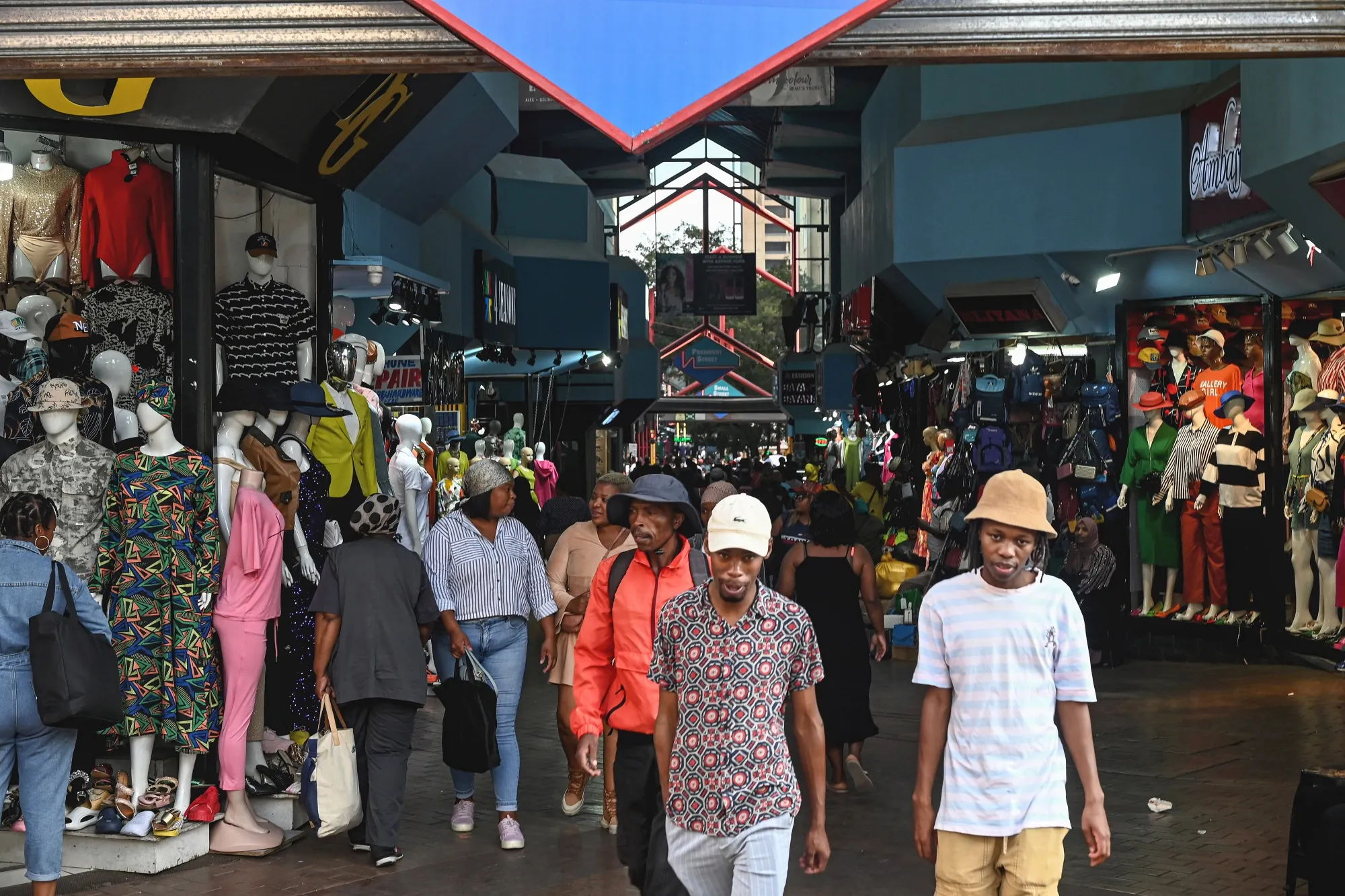 Shoppers pass stores in Johannesburg.