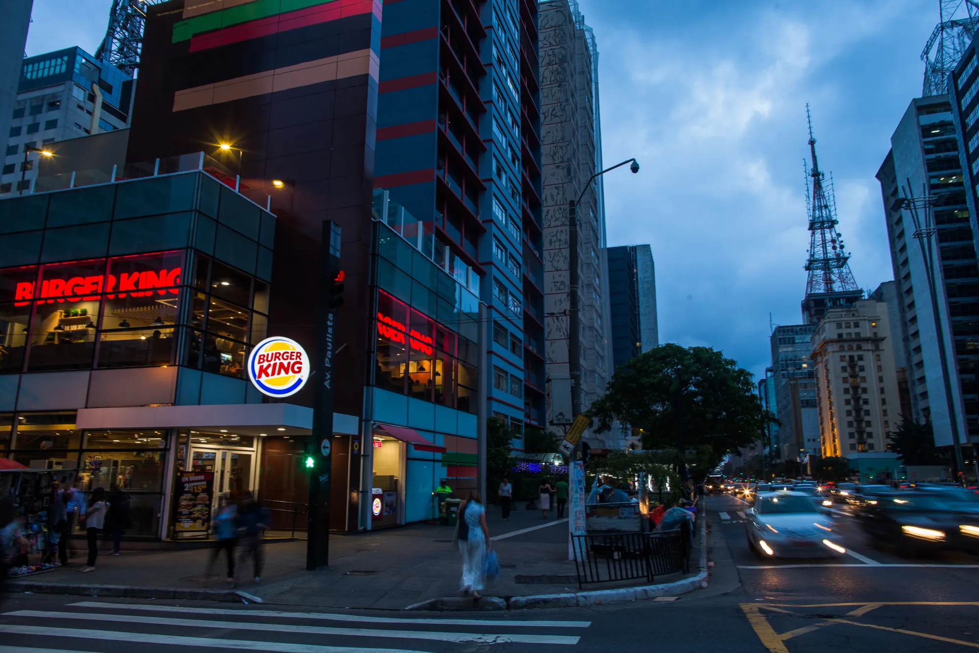 Pedestrians pass in front of a Burger King in Sao Paulo.