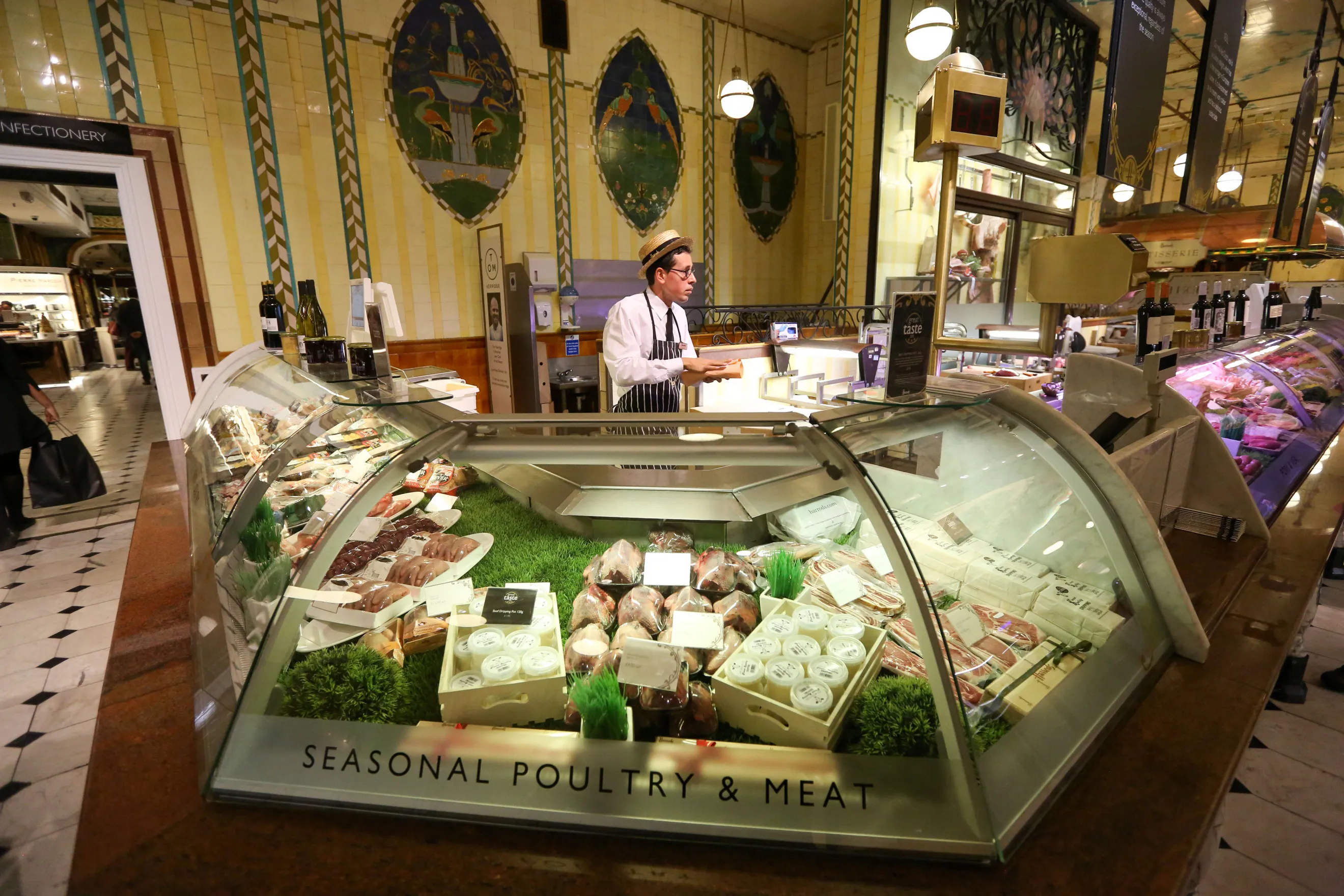 A employee serves behind the meat counter inside&nbsp;Harrods Ltd in London, U.K.