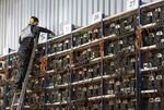 An engineer&nbsp;inspects racks of mining devices at a cryptocurrency mining farm in Norilsk, Russia.