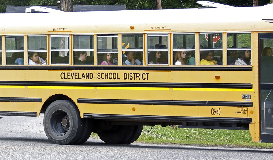 An integrated group of students in Cleveland, Mississippi, ride the bus home from school.