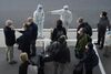 World Health Organization members are directed on their arrival at Wuhan airport, on Jan. 14.