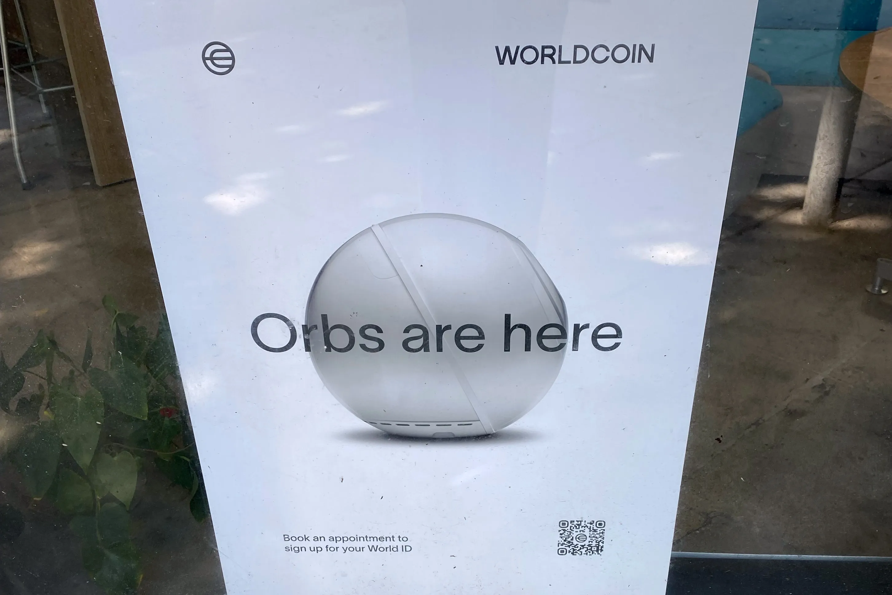 A Worldcoin poster hanging in the window of a Blankspaces co-working space in Santa Monica, California, on July 26.&nbsp;