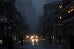 Vehicles drive down Bourbon Street during a city-wide power outage caused by Hurricane Ida in New Orleans, on Aug. 29.