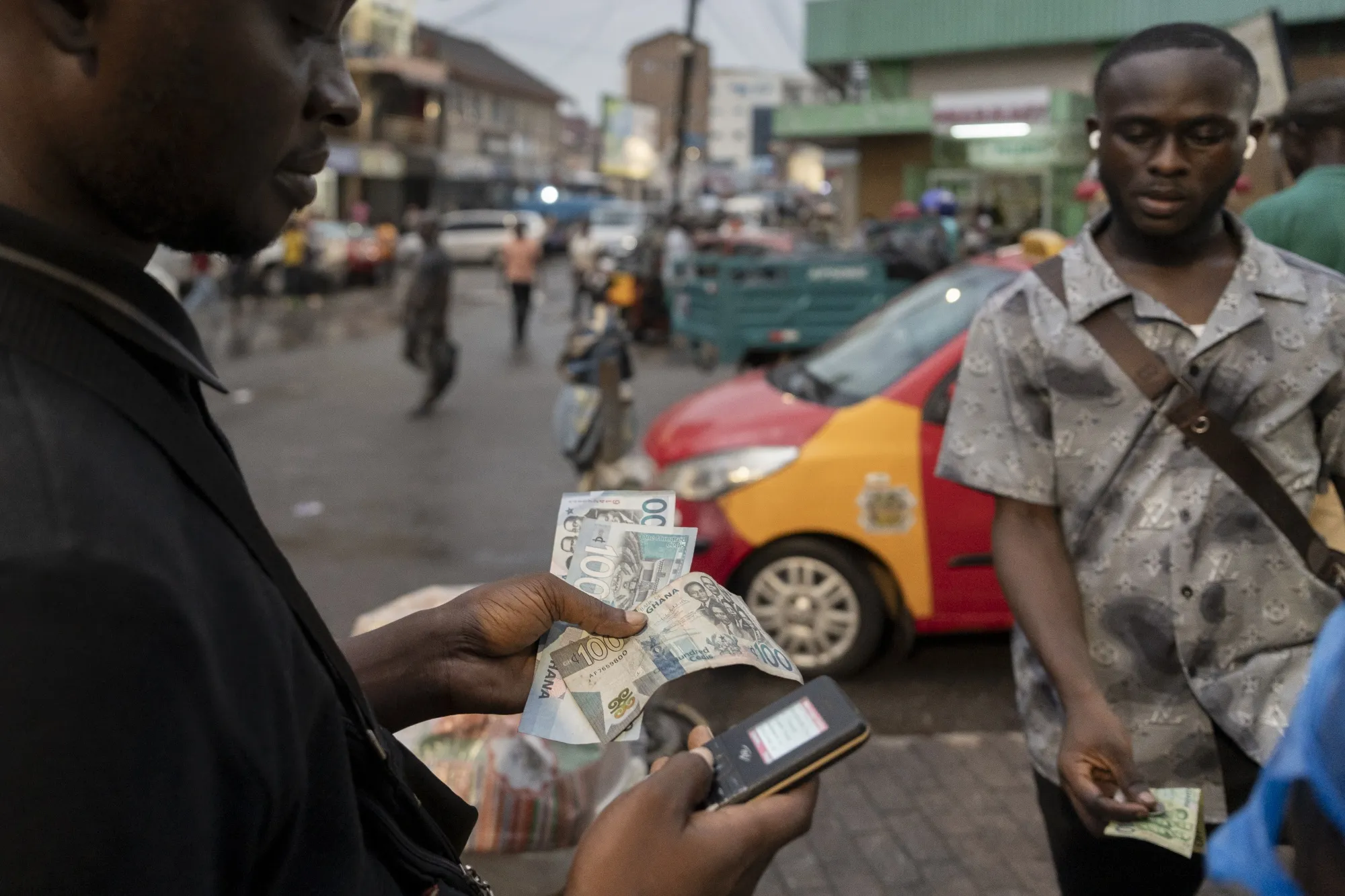 A mobile money vendor in Kumasi, Ghana.
