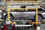 Workers install batteries onto an electric SUV at a Nio production facility in&nbsp;China, on Dec. 4.