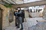 Israeli police officers wearing face masks patrol on a street in Mea Shearim neighborhood in Jerusalem, on April 8.