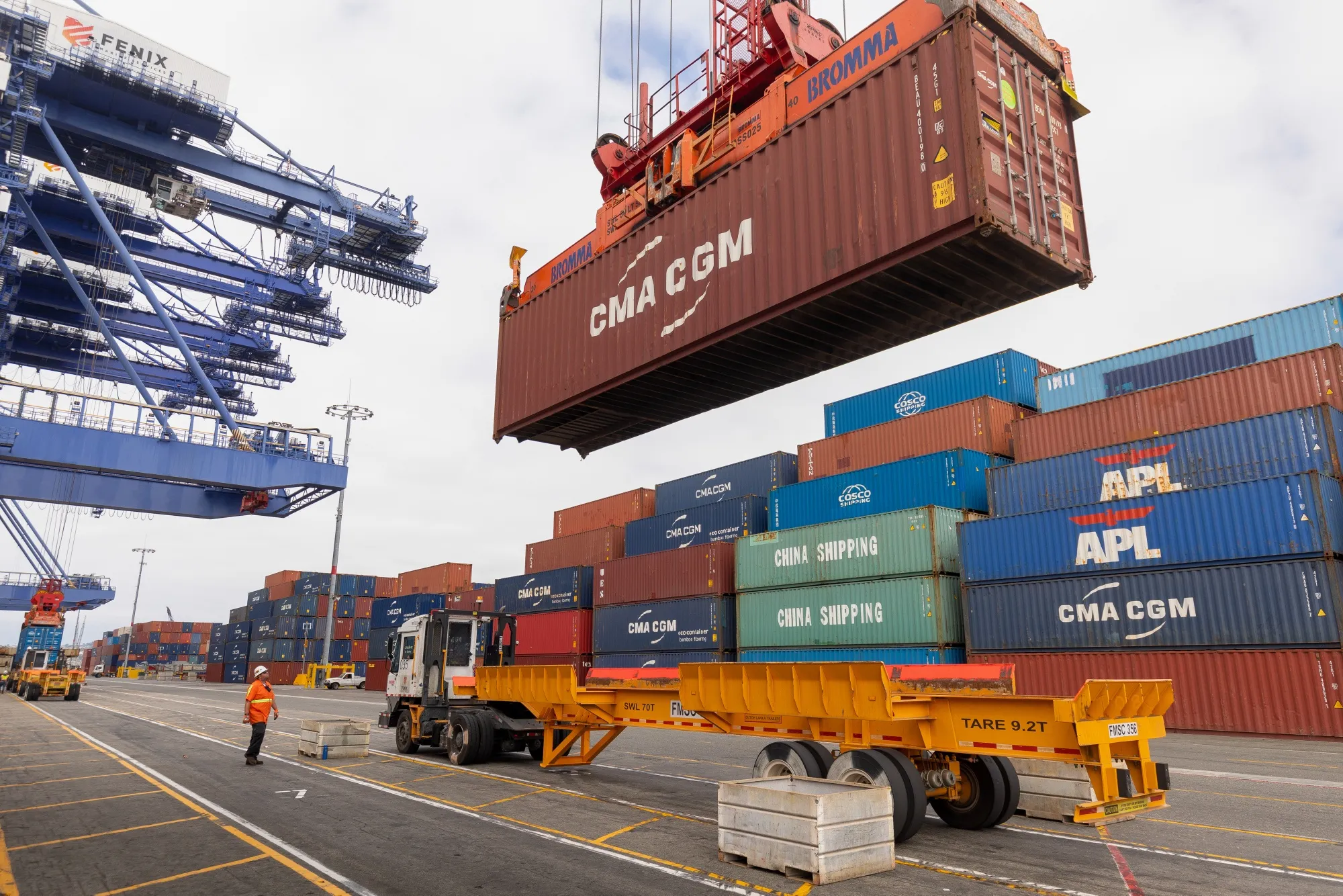 Cranes unload CMA CGM shipping containers at the Port of Los Angeles in August.