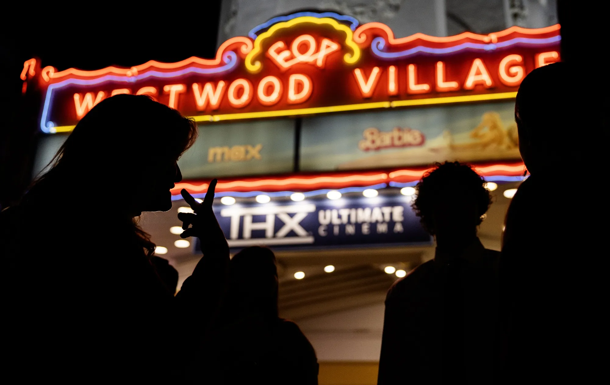 A movie-goer uses sign language outside the Regency Westwood Village Theater in Westwood.