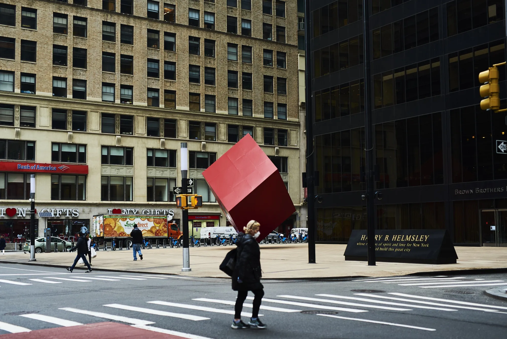 A pedestrian wearing a protective mask walks through the Financial District of New York on March 30.