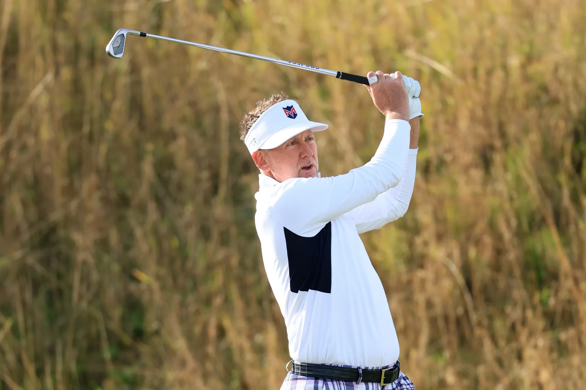 Ian Poulter tees off during the Alfred Dunhill Links Championship at Kingsbarns Golf Links in St Andrews, UK, on Oct. 3.