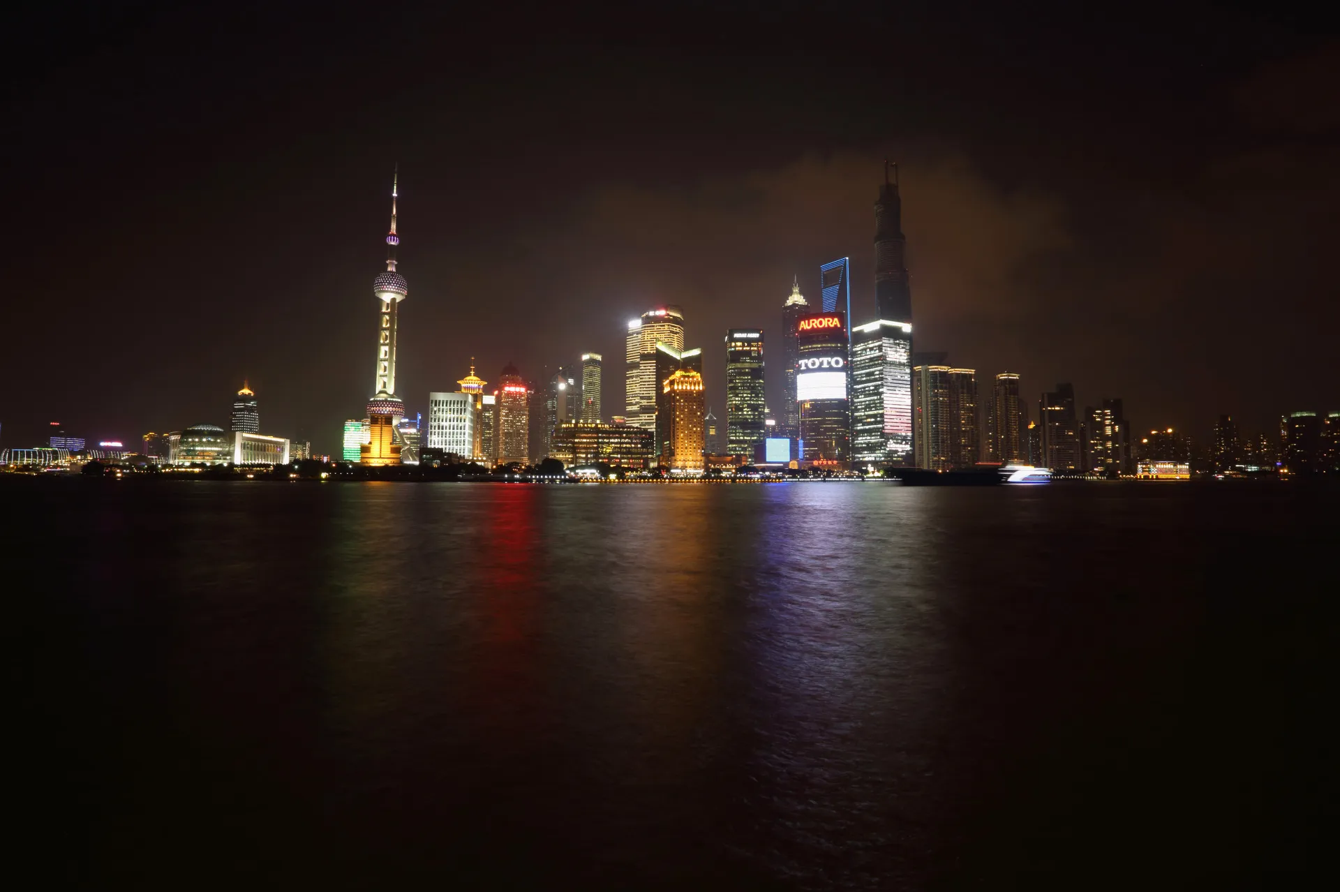 Buildings in the Lujiazui district stand at night, seen from the bund area, in Shanghai.