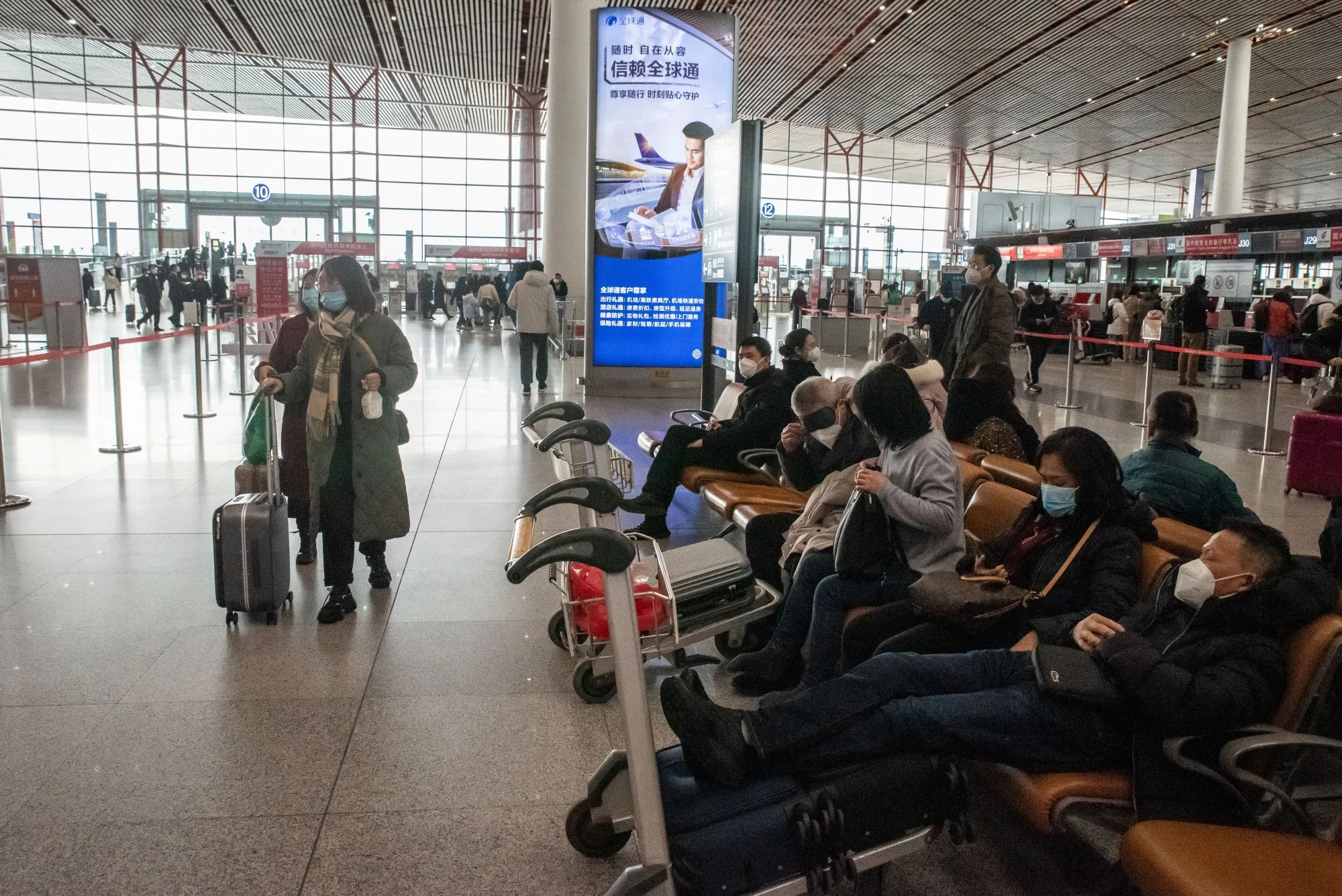 Travelers at Beijing Capital International Airport on Jan. 14.
