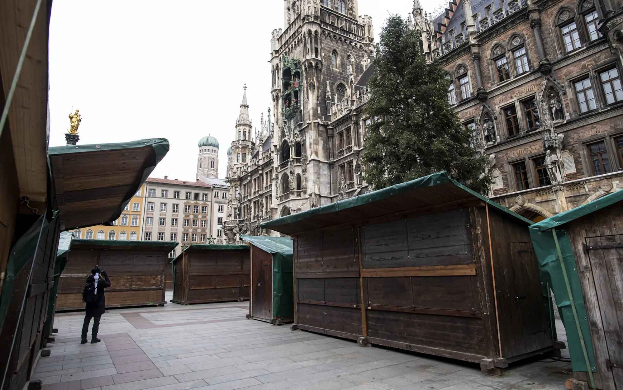 A visitor at the closed&nbsp;booths of the cancelled Christmas market in&nbsp;Munich, on Nov. 20.
