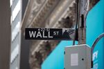 A Wall Street street sign is displayed in front of the New York Stock Exchange (NYSE) in New York, U.S., on Thursday, Feb. 11, 2021. Signify Health Inc. opened trading at $32 after its $564 million IPO priced at $24 per share, above its $20 to $21 offering range.