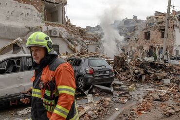 Emergency services work at the site of a Russian attack on residential buildings in Kyiv, in September.
