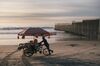 A vendor pushes a cart with snacks and beach toys for sale on a beach near a section of the U.S. and Mexico border wall in Tijuana, Mexico, on Monday, Nov. 27, 2018. Two-way trade between Mexico and the U.S. totals about $1.3 billion per day, according to Mary E. Lovely, an economist at Syracuse University. After the U.S. shocked locals by closing San Ysidro for more than four hours on Sunday, the immediate concern is another limited shutdown that would hit commercial traffic between the two countries.