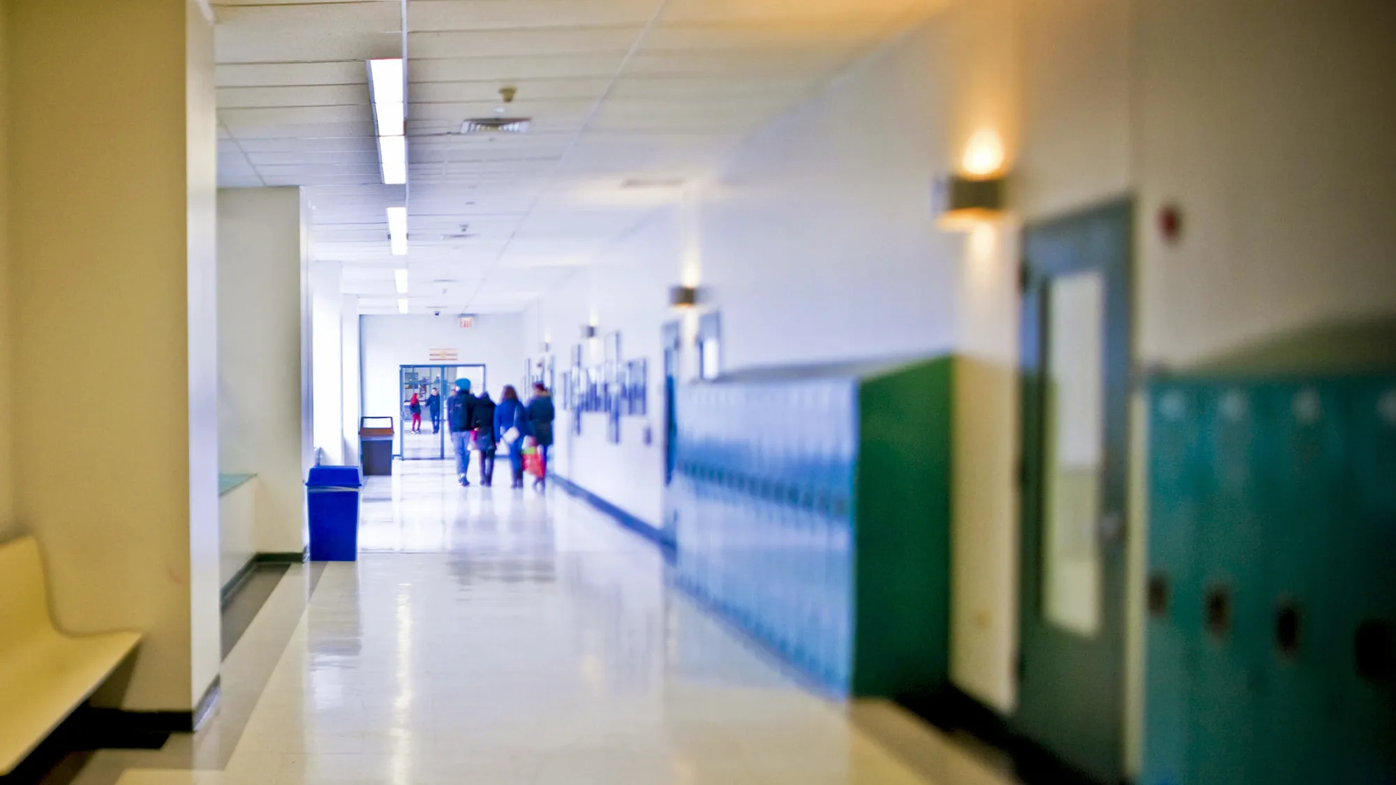 In this photo taken with a tilt-shift lens, students walk through a hallway at LaGuardia Community College in the Queens borough of New York, U.S., on Thursday, Dec. 23, 2010. For-profit colleges are gaining students over community colleges as they compete to educate low-income students, even though private schools charge as much as ten times for the same degree and their students are eight times more likely to be in debt.
