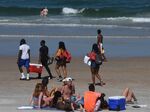 People gather at Daytona Beach during spring break on March 20, after Florida Governor Ron DeSantis refused to order the state's beaches closed. Local officials had closed other Florida beaches.