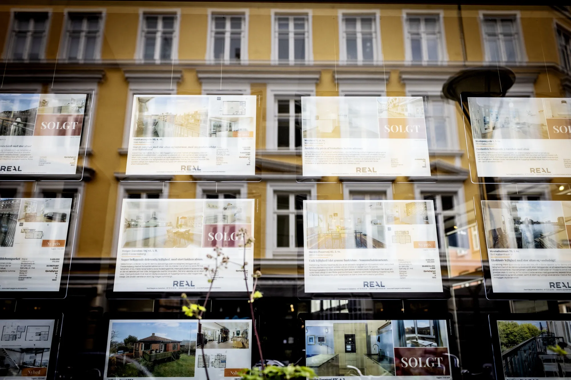 Property for sale inside a real estate agent's window in Copenhagen.