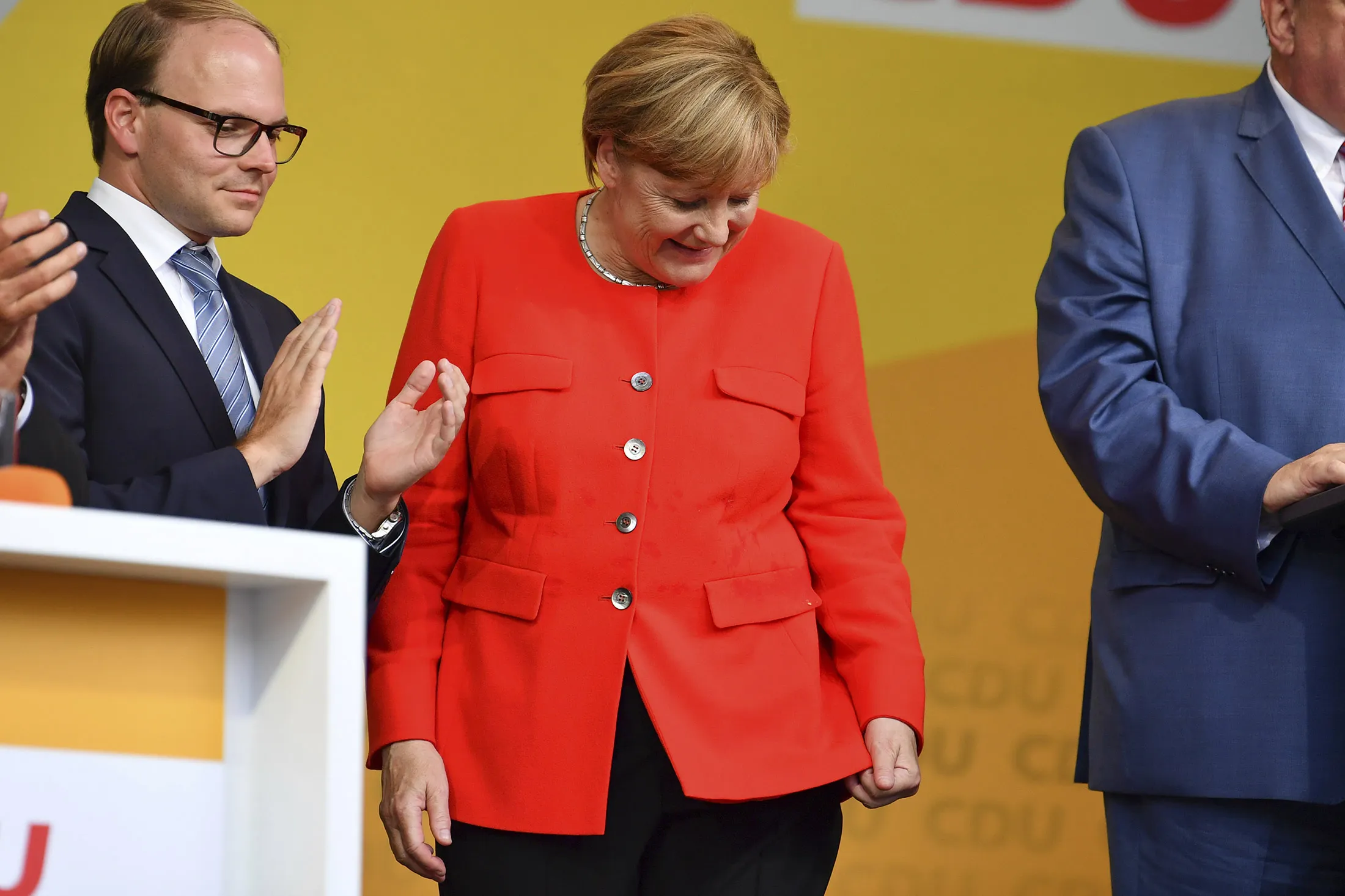 German Chancellor Angela Merkel looks at a stain on her jacket during a campaign event at the University Square in Heidelberg, Germany, on Sept. 5.
