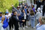 Venezuelan migrants and volunteers celebrate together outside of St. Andrew's Parish House in Martha's Vineyard on Sept. 16.&nbsp;