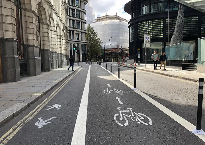 Pedestrian and cycle lane markers sit on a road in the City of London, on Sept. 25.