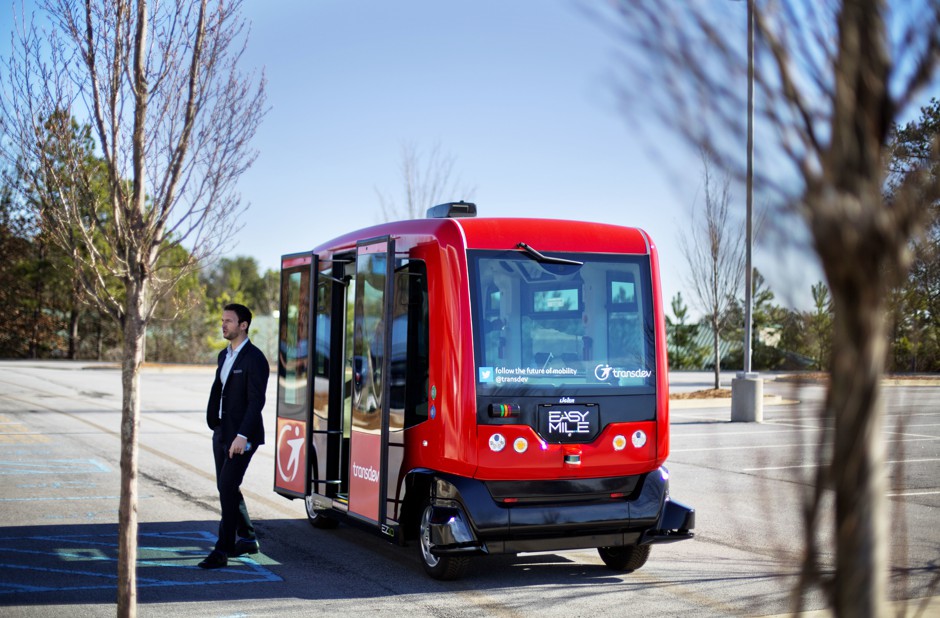 A passenger leaves an EasyMile driverless shuttle bus at the Riverside EpiCenter in Austell, Georgia in 2017.