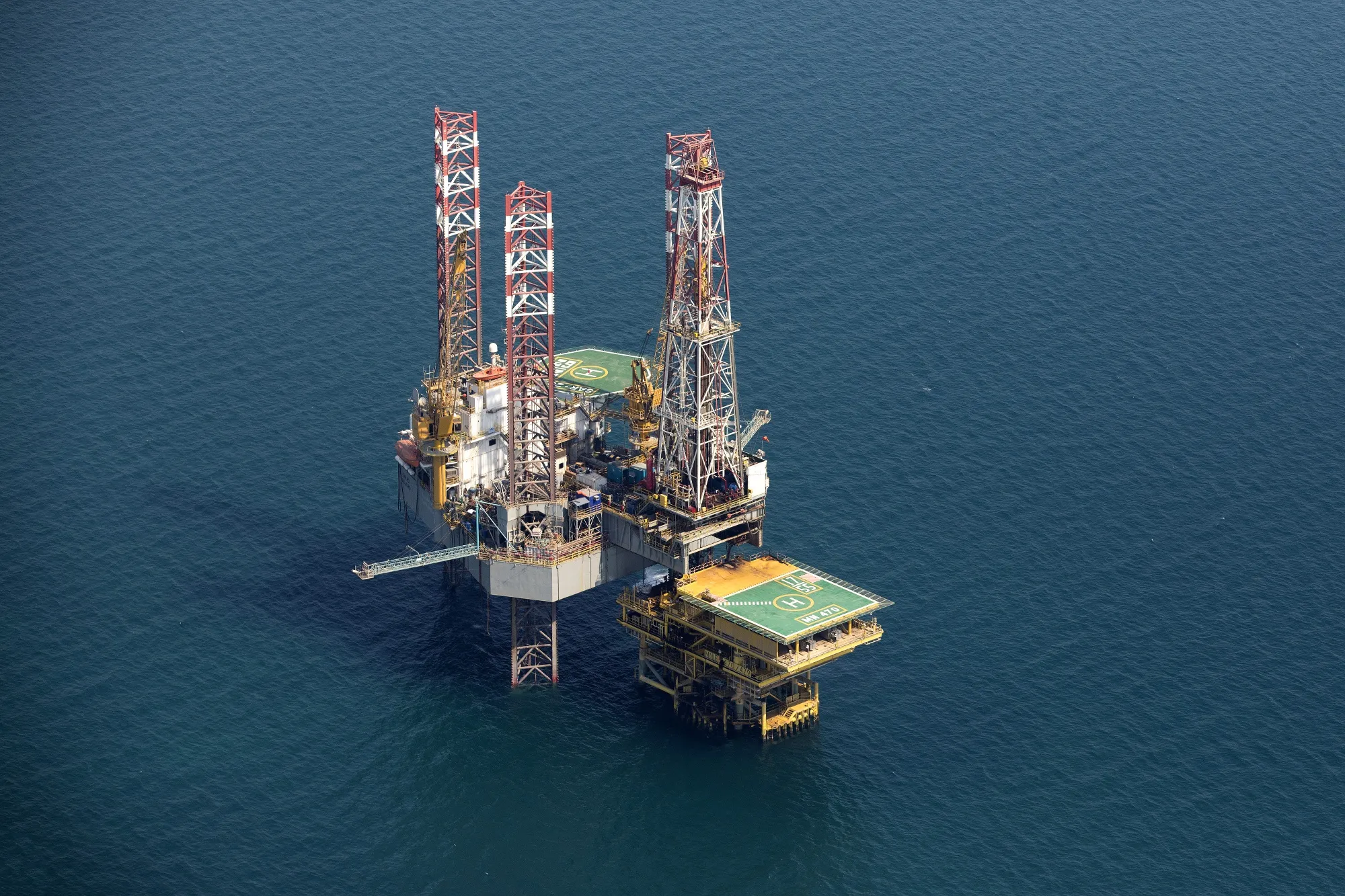 An offshore drilling platform stands in shallow waters at the Manifa offshore oilfield, operated by Saudi Aramco.